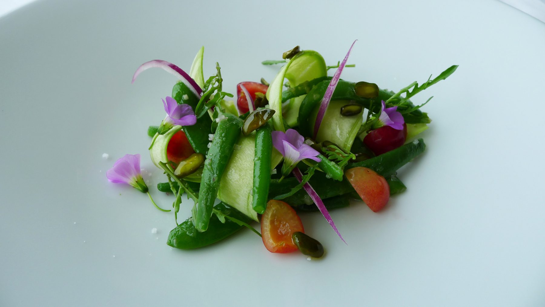 Green beans salad with cherries and pistachios, zucchini and onions