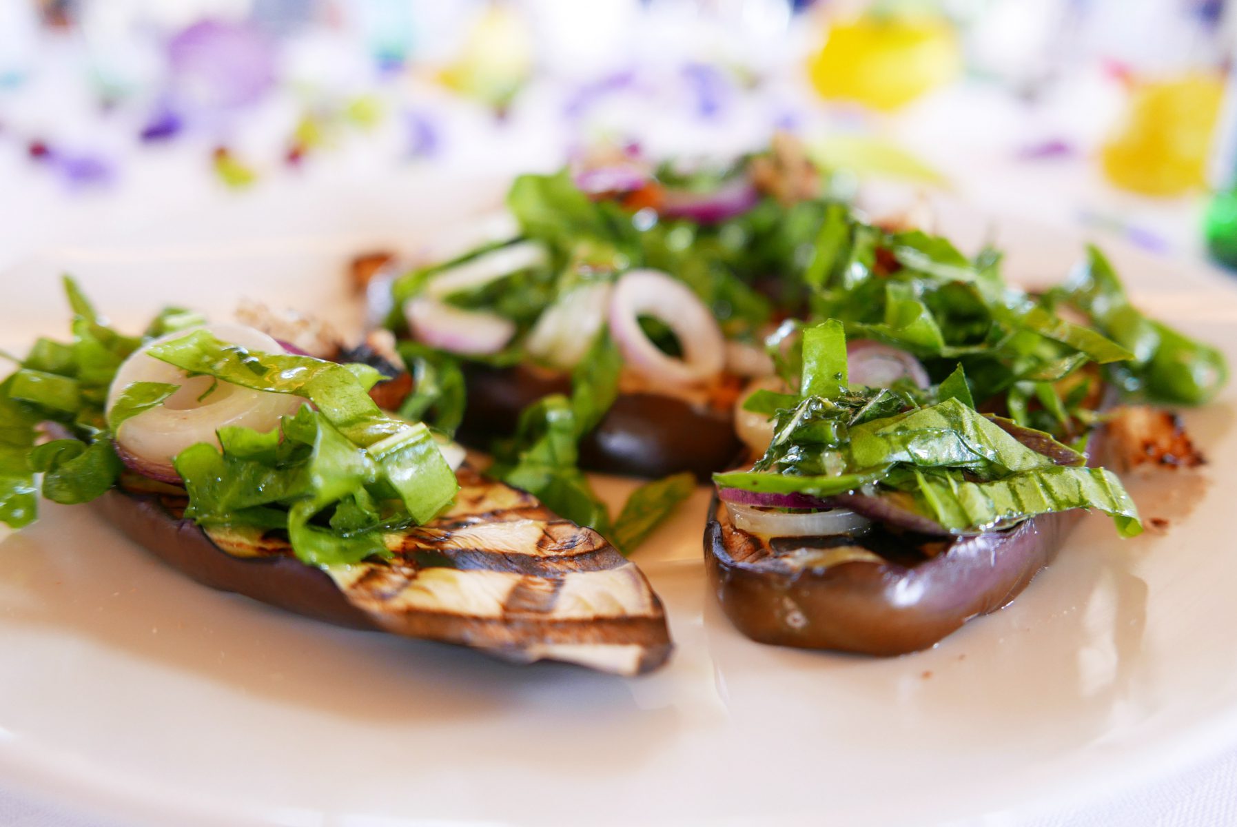 Grilled eggplant with mint, red basil and onion