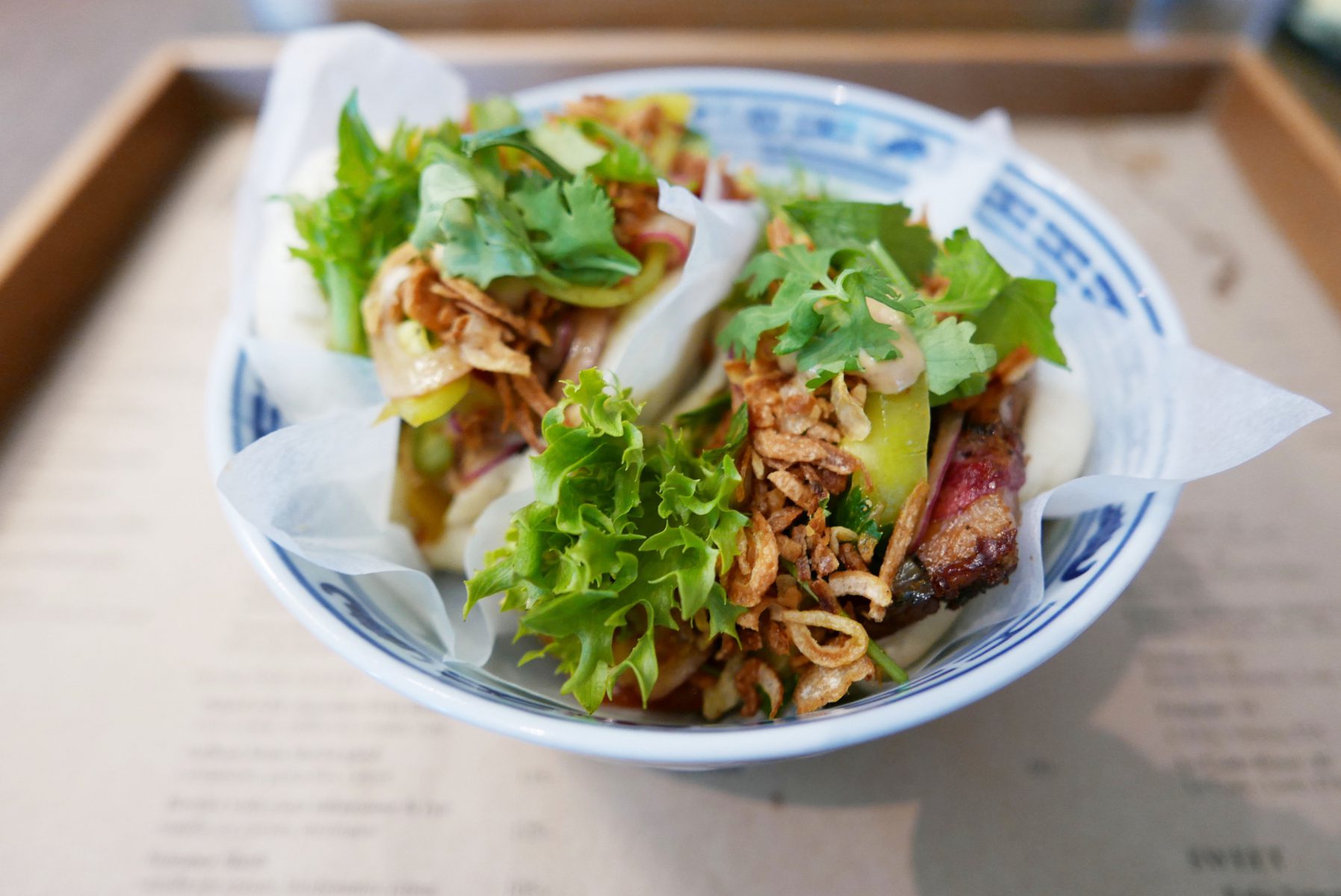 Steamed BBQ style bun with brisket,smoked and pickled peppers,onion