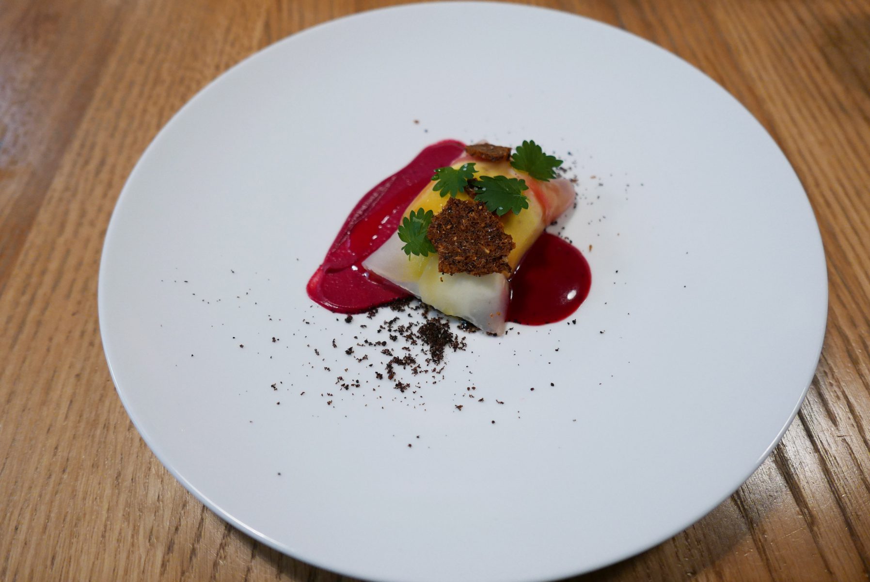 Burrata de Sanza, beetroot ravioli,prune vinegar and black olive