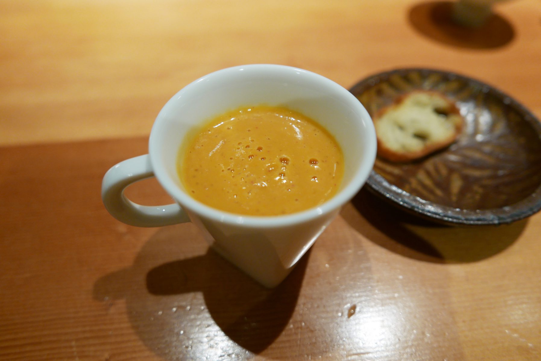 Leftover soup with a slice of baguette.(fish and vegetables)