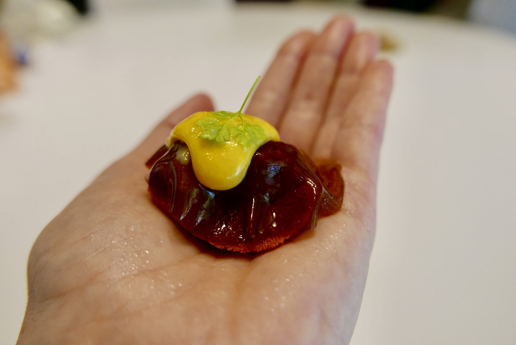 Sea urchin on your hand with finger lime, liquorice and black garlic veil, Japanese Bearnaise and bergamot perfume at DiverXo (3*),Madrid