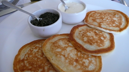 "Pancakes with black caviar"