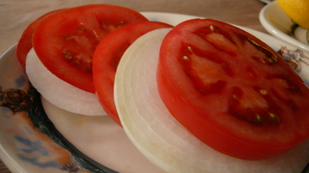 Sliced beefsteak tomato and onions