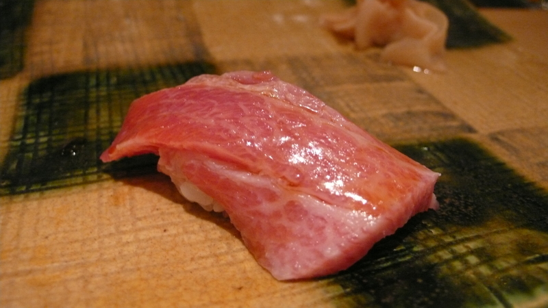 Bonito tuna sushi with crushed garlic on the top