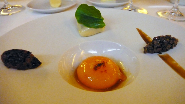 Poached egg yolk with tapenade and olive oil ravioli