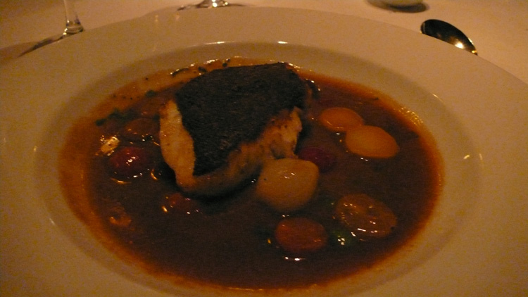 Black sea bass crusted with nuts and seeds, sweet and sour jus