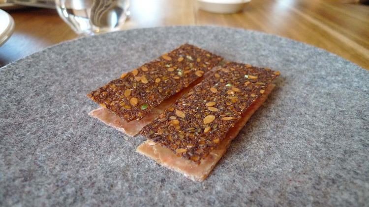 Toasted rye bread sandwiches with chicken skin, cheese cream and fava beans