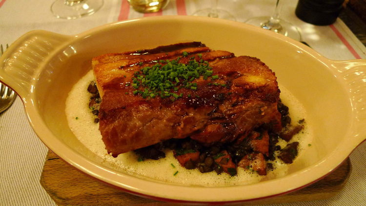 Crispy pork with green Puy lentils