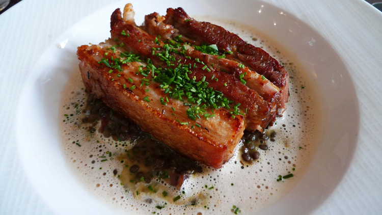 Crispy pork belly with green Puy lentils in petit salé style