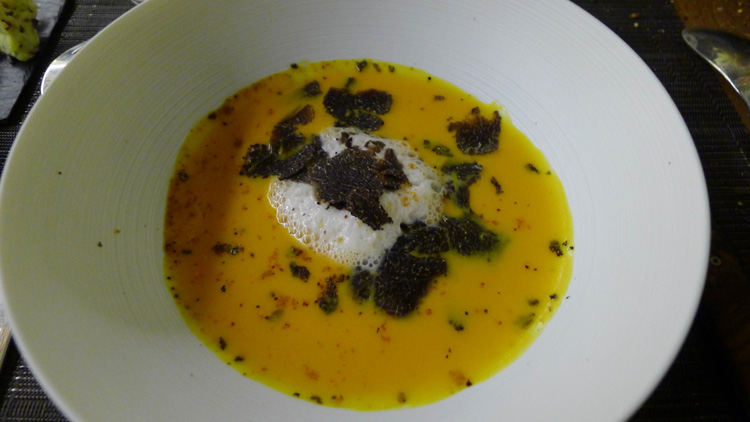Pumpkin and speck ham soup with black truffle shavings 
