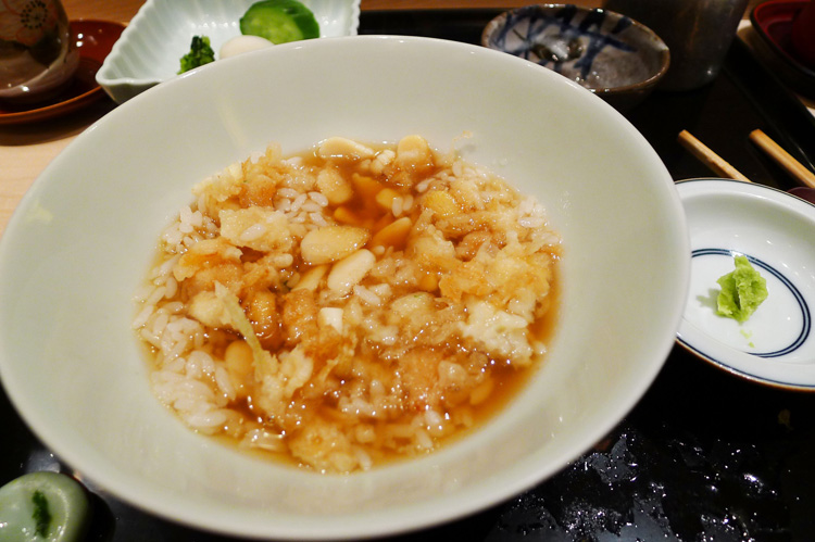 Ten- cha- kakiage on a bowl of rice. Kakiage is a mixture of bits of scallops and  honewort fried in batter. It's served with special Japanese tea.