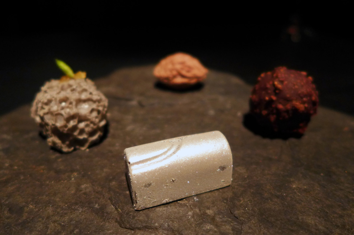 Peach pit, black sesame rock, raspberry bonbon, crispy chocolate ball...