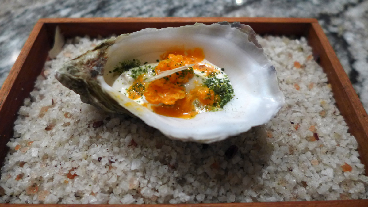 Oyster ”45 min” with frozen sea buckthorn, cream flavored with juniper, berries & walnut.