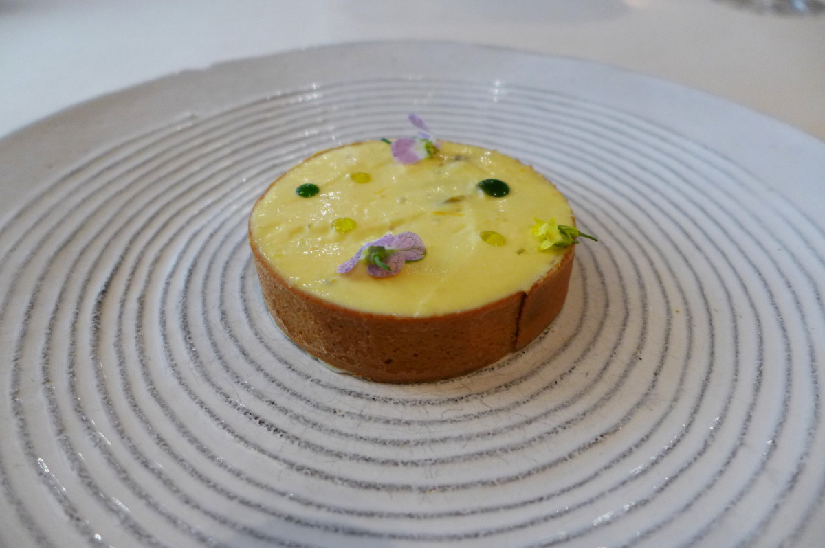 Citrus tartelette (with citrus fruit pulp layer underneath the cream), olive oil and parsley