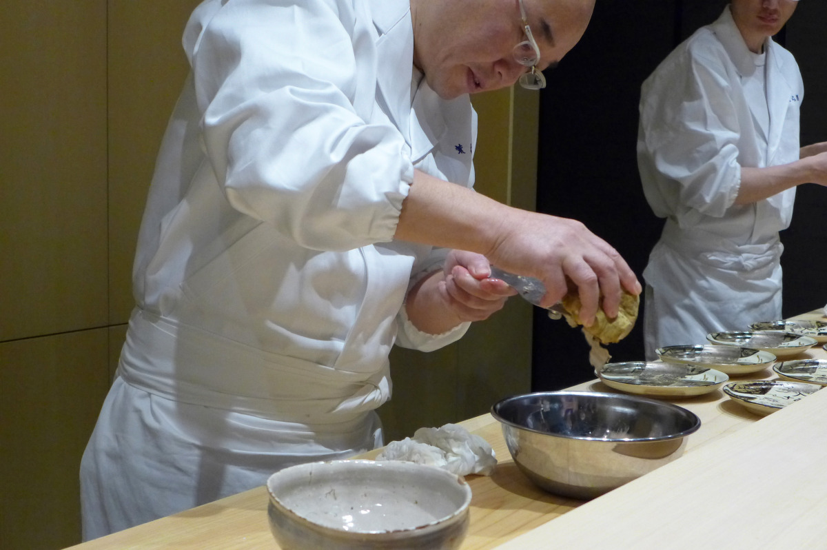 Shaving white truffles on tuna tartare