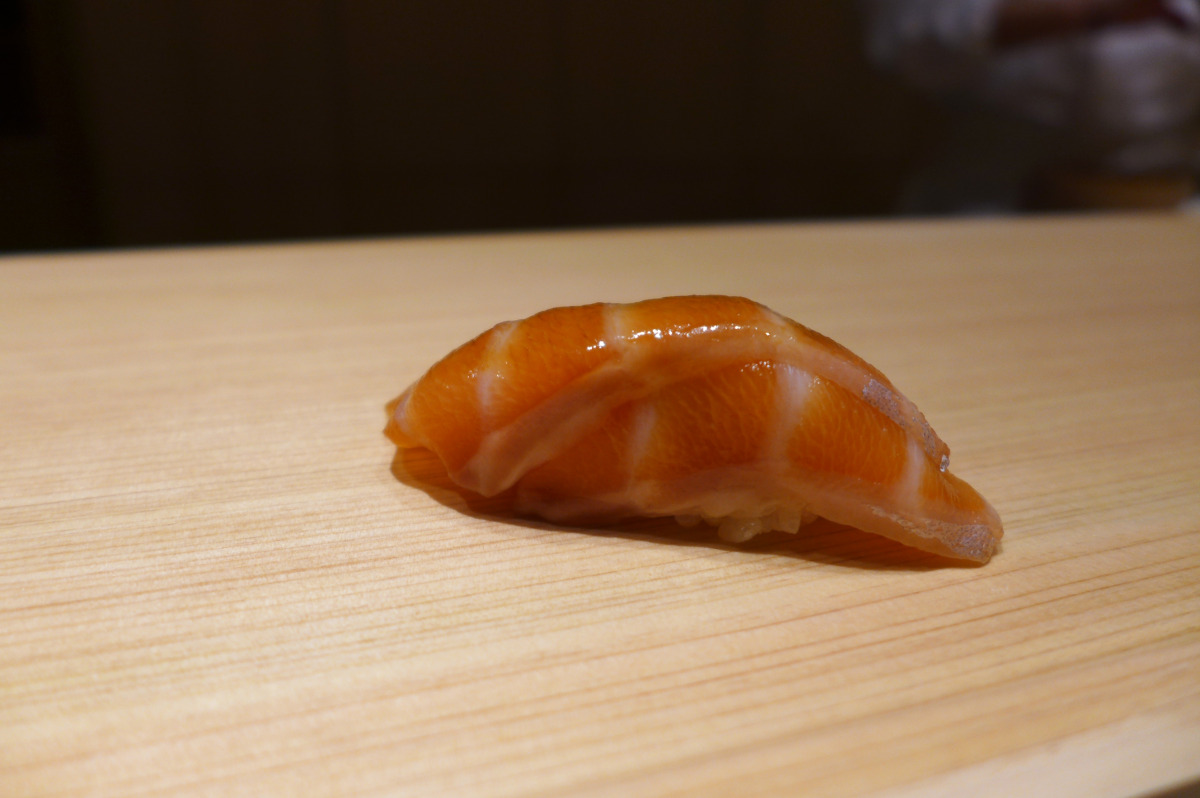 Scottish salmon sushi. It's kind of "neta" ( sushi topping) that you will never get at the Tokyo heavyweights. Salmon is not used by sushi chefs in Japan that much. I found it very good though. The salmon was briefly dipped in soy sauce before serving.