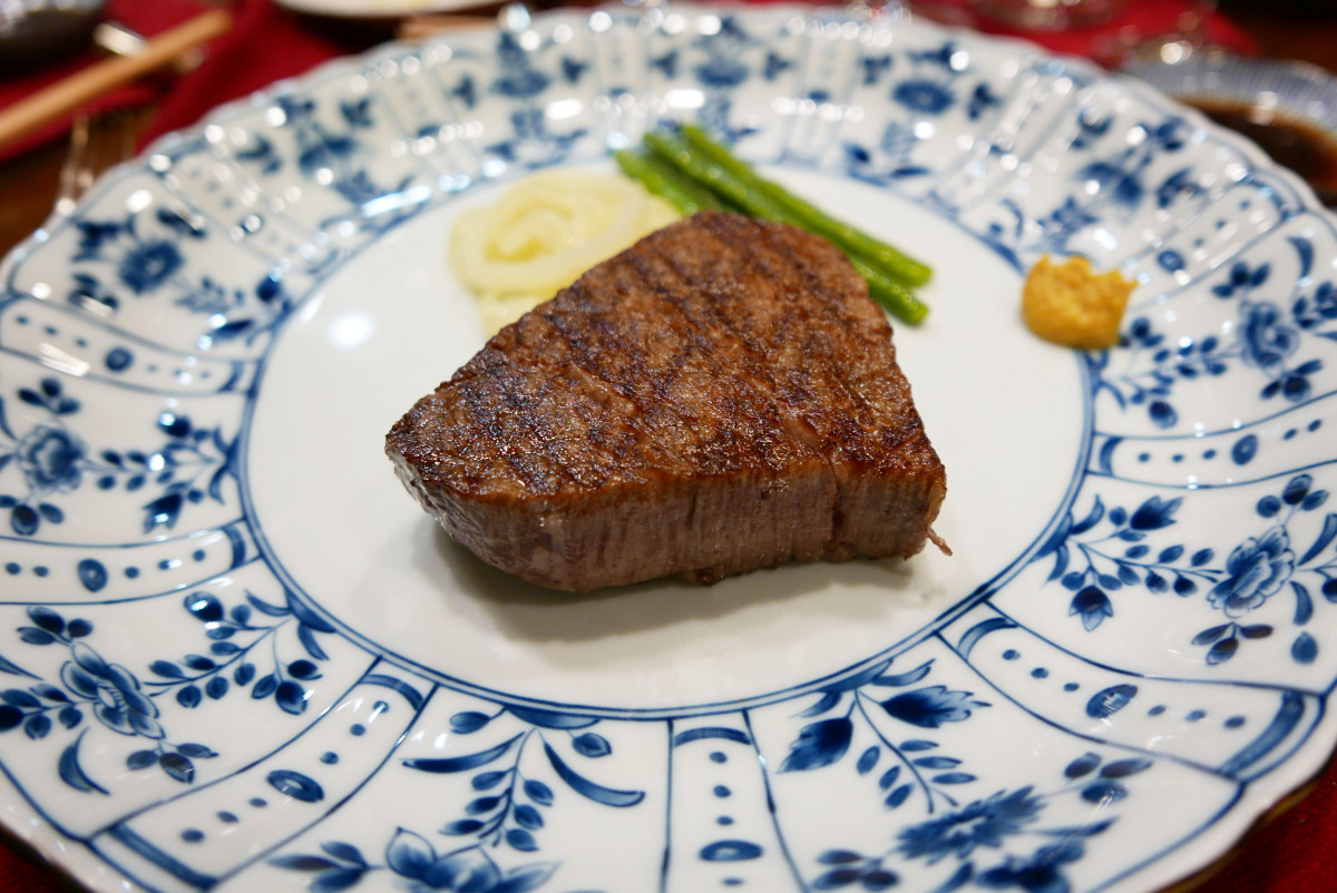 The steak is grilled over binchotan grill