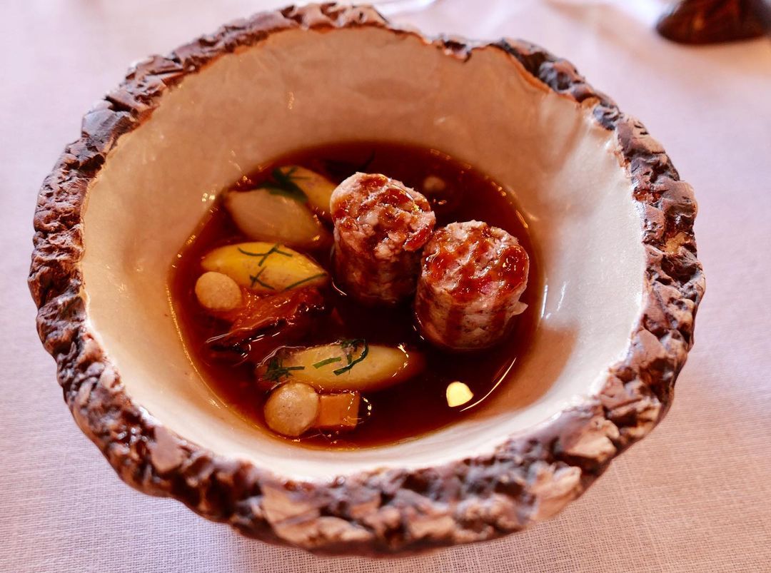 Pork sausage cooked in consommé with boiled potatoes (great dish!)