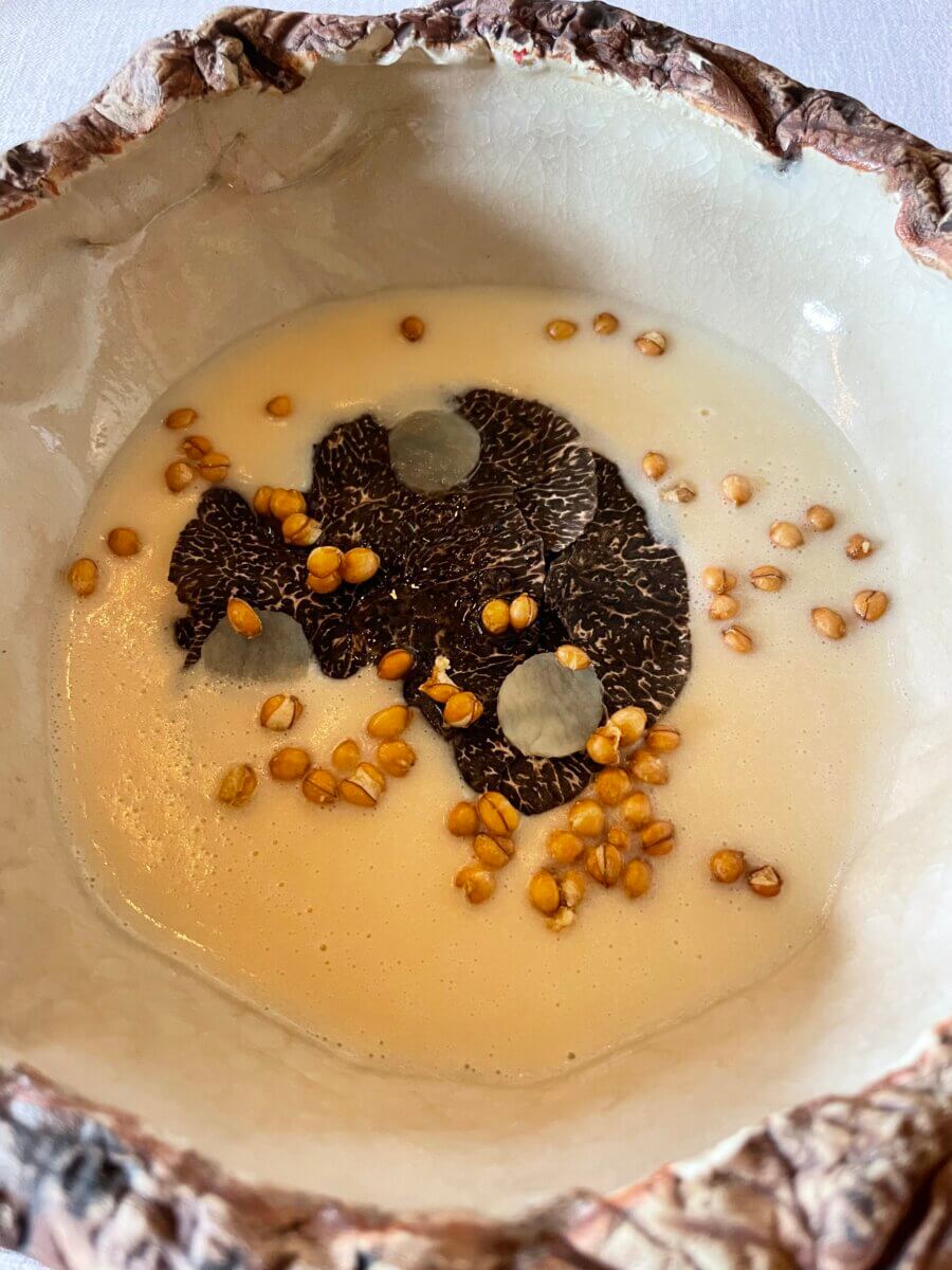 Potato velouté with sliced truffle.